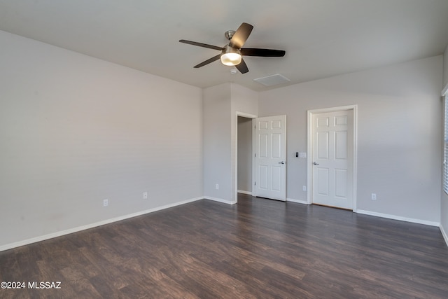 unfurnished bedroom featuring ceiling fan and dark hardwood / wood-style flooring