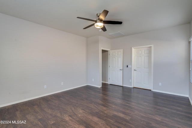 unfurnished bedroom with baseboards, dark wood finished floors, and a ceiling fan