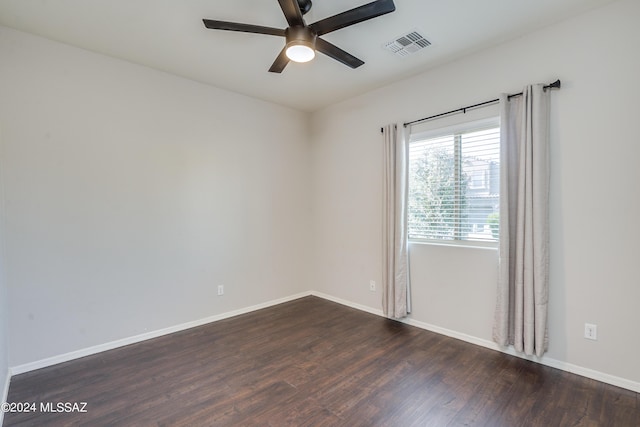 spare room featuring a ceiling fan, baseboards, visible vents, and wood finished floors