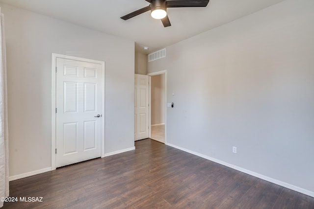 unfurnished bedroom with ceiling fan and dark hardwood / wood-style flooring