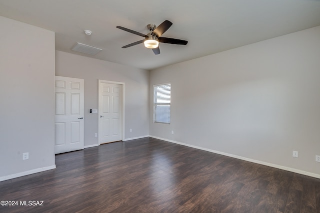 unfurnished bedroom with ceiling fan and dark hardwood / wood-style floors