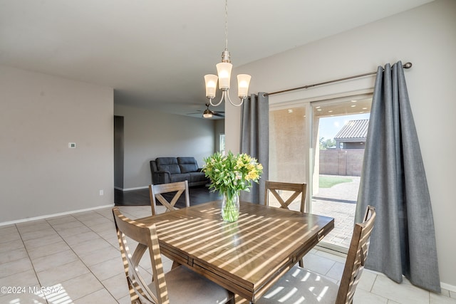 dining area featuring ceiling fan with notable chandelier and light tile patterned floors