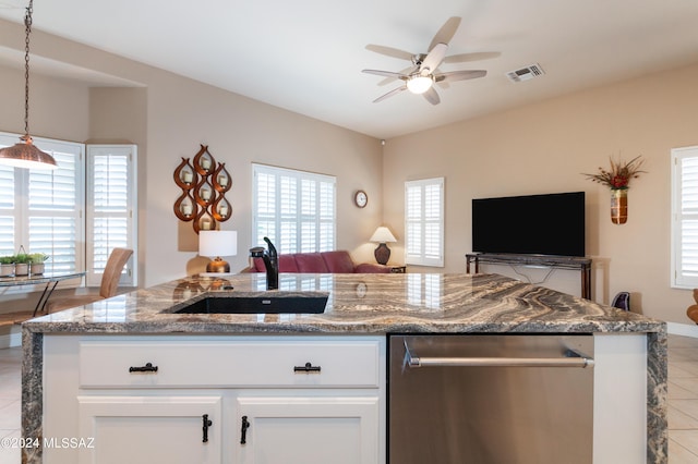 kitchen featuring visible vents, open floor plan, dishwasher, stone countertops, and a sink