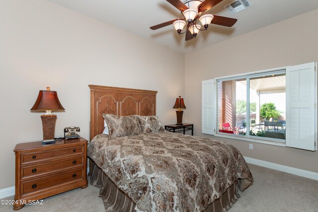 bedroom with ceiling fan and light colored carpet