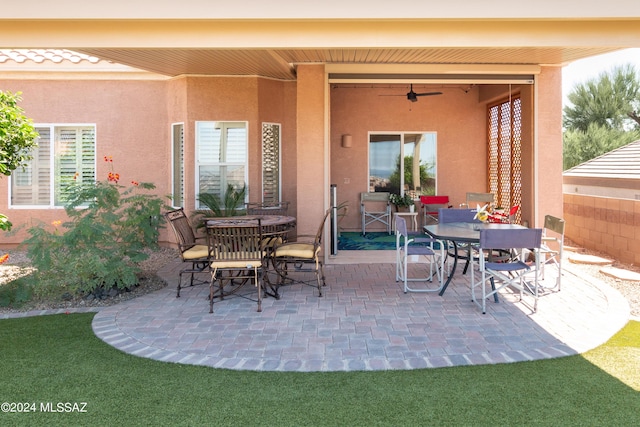 view of patio featuring outdoor dining space and ceiling fan