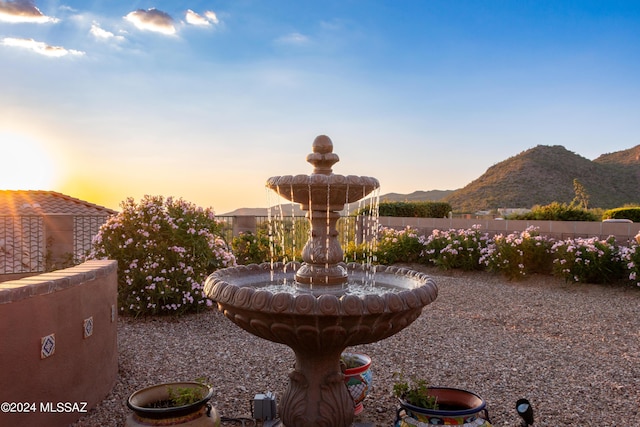 surrounding community with a mountain view and fence