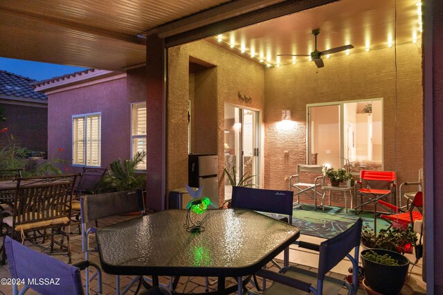 view of patio with outdoor dining area and a ceiling fan