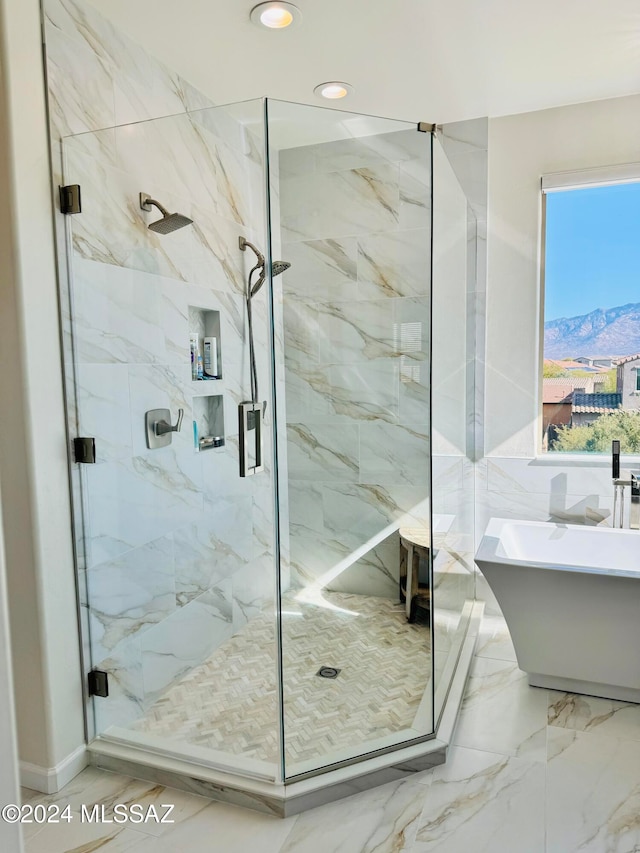 bathroom featuring a mountain view and separate shower and tub