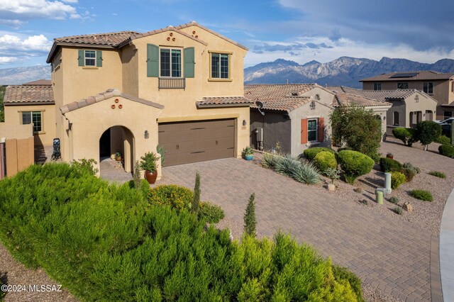 mediterranean / spanish-style house with a mountain view and a garage