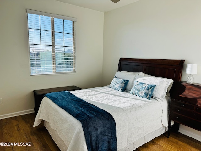 bedroom with dark hardwood / wood-style flooring