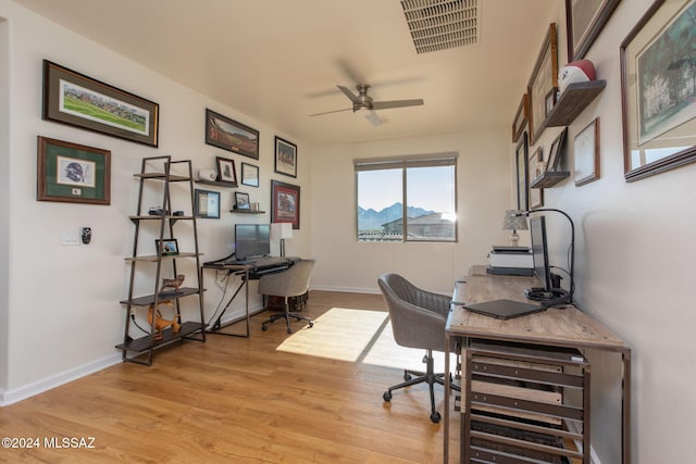 office area with light hardwood / wood-style flooring and ceiling fan