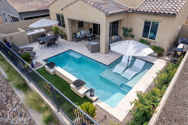 view of swimming pool with an outdoor hangout area, central AC unit, a patio area, and exterior kitchen