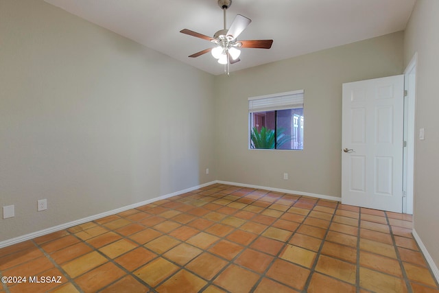 tiled spare room with ceiling fan