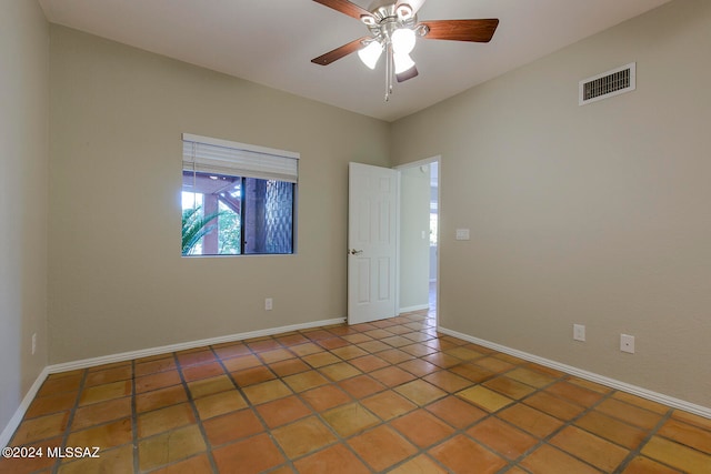 tiled empty room with ceiling fan