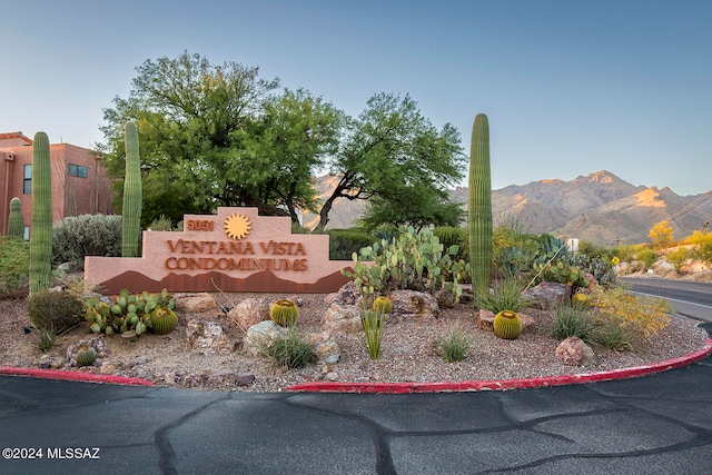 community sign with a mountain view