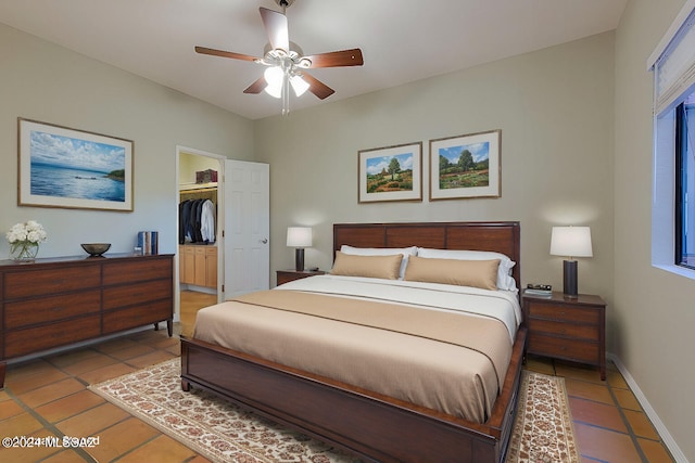 bedroom featuring tile patterned flooring, a spacious closet, a closet, and ceiling fan