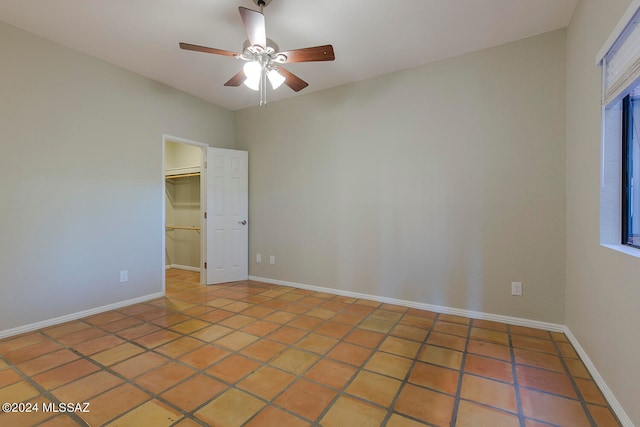 unfurnished room featuring tile patterned flooring and ceiling fan