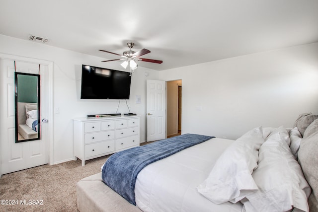 bedroom featuring light colored carpet and ceiling fan