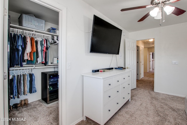 interior space with a closet, light colored carpet, and ceiling fan