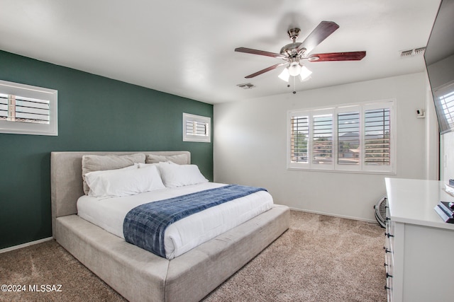 bedroom with ceiling fan and carpet floors