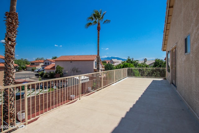 view of patio with a mountain view and a balcony