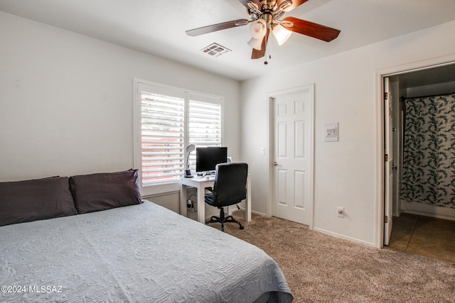 carpeted bedroom featuring ensuite bath and ceiling fan