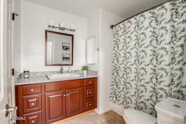 bathroom featuring vanity, toilet, walk in shower, and tile patterned flooring