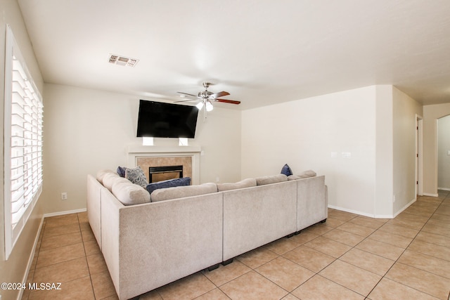 tiled living room with ceiling fan