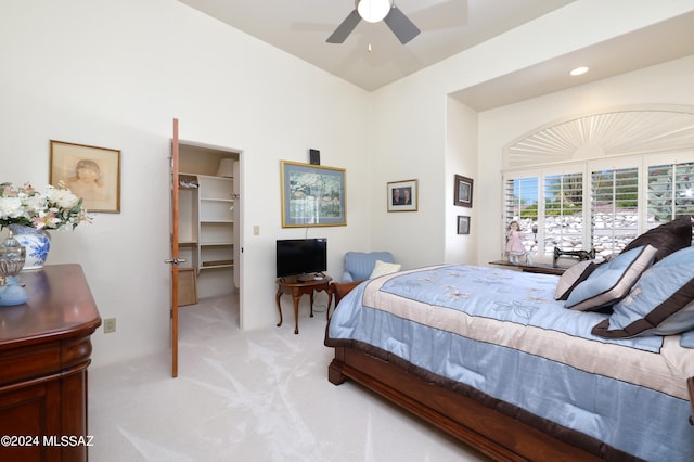 carpeted bedroom featuring a spacious closet, a closet, and ceiling fan