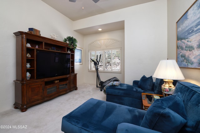 living room featuring light carpet and ceiling fan