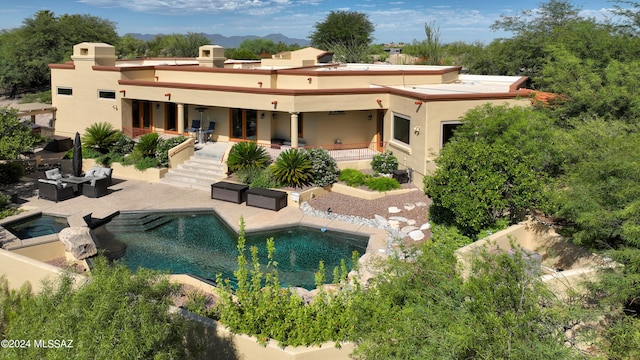 back of property featuring an outdoor living space and a patio