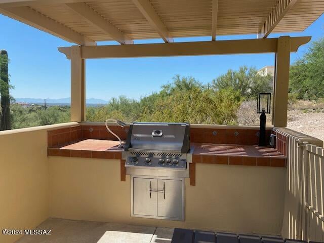 view of patio featuring area for grilling and an outdoor kitchen