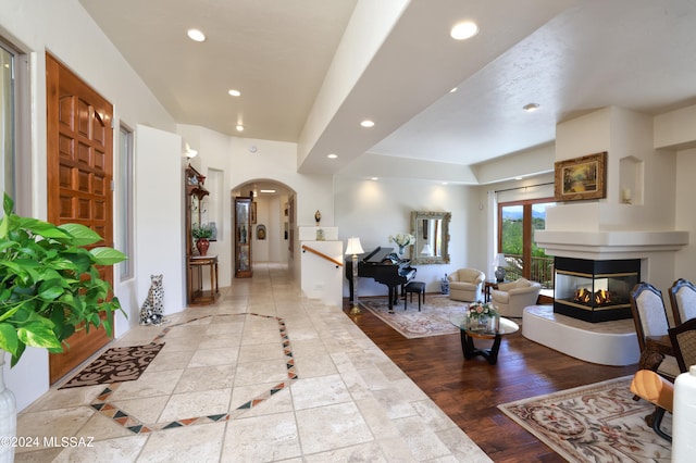 living room featuring a multi sided fireplace and light wood-type flooring