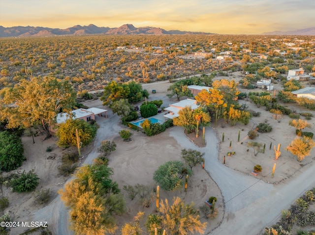 aerial view at dusk featuring a mountain view