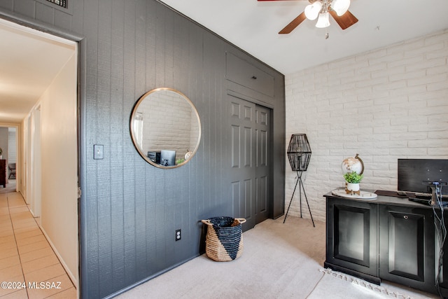 home office featuring brick wall and ceiling fan