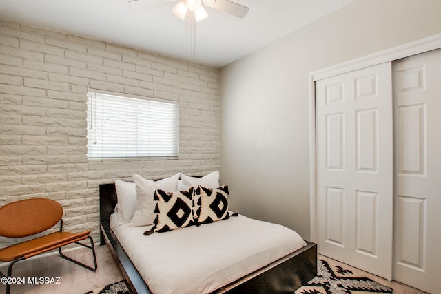 empty room with light carpet, brick wall, and ceiling fan