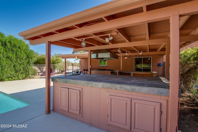 view of patio featuring area for grilling and exterior bar