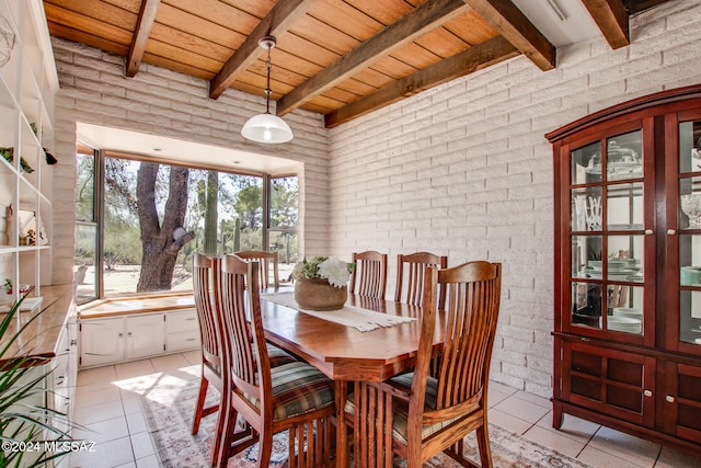 dining space with beamed ceiling, ceiling fan, a fireplace, and wooden ceiling