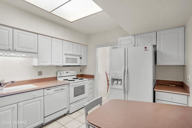 kitchen featuring sink, light tile patterned floors, white appliances, and white cabinetry