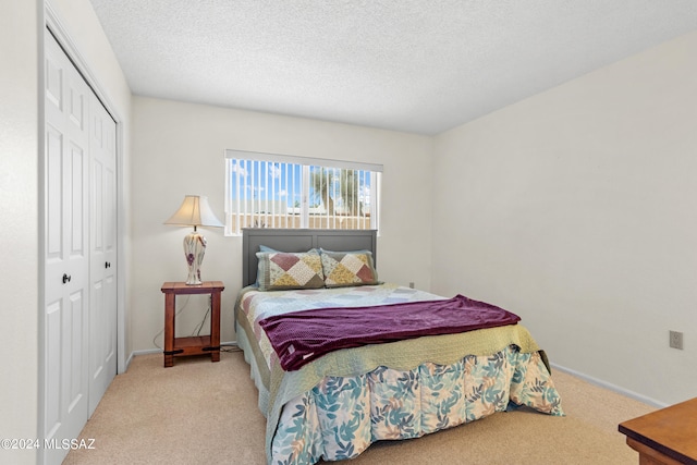 bedroom featuring a closet, carpet, and a textured ceiling