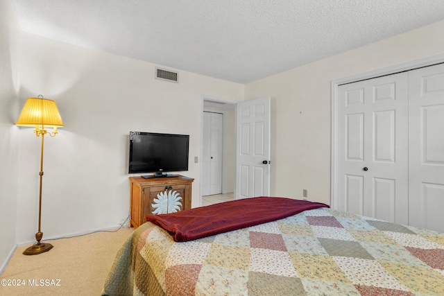 carpeted bedroom with a textured ceiling