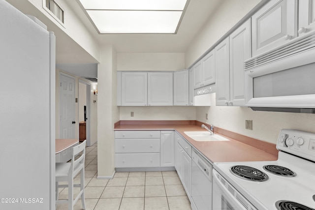 kitchen with white cabinetry, white appliances, sink, and light tile patterned flooring