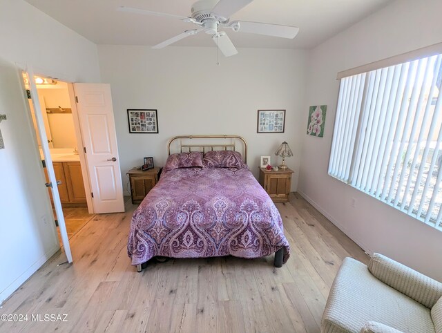 bedroom featuring light hardwood / wood-style flooring, ceiling fan, and ensuite bathroom