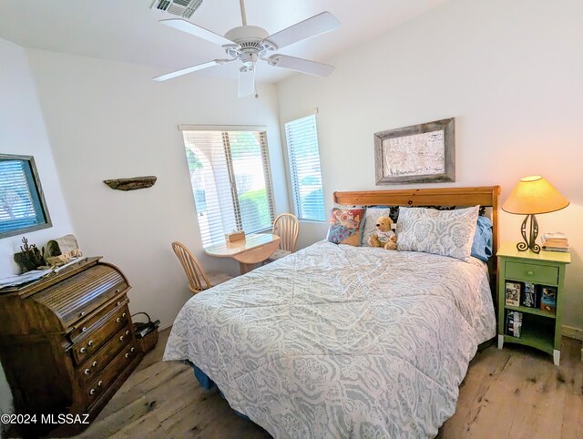 bedroom with light hardwood / wood-style flooring and ceiling fan