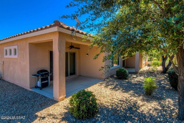 back of house featuring ceiling fan and a patio