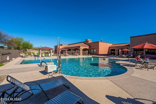 view of swimming pool featuring a gazebo and a patio