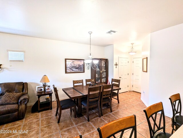 dining area featuring dark tile patterned floors