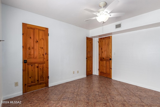 tiled empty room with ceiling fan