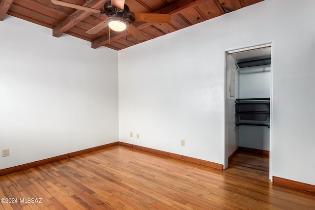 spare room featuring wooden ceiling, hardwood / wood-style flooring, beamed ceiling, and ceiling fan