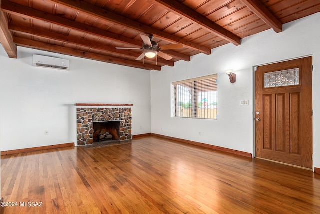 unfurnished living room with wooden ceiling, beamed ceiling, a wall mounted AC, a fireplace, and wood-type flooring